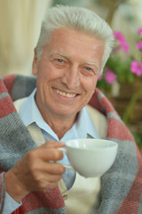 happy elderly man drinking tea