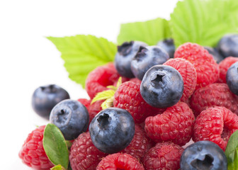 Many blueberries, raspberries. Isolated white