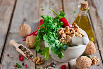 Cilantro and walnuts in a mortar