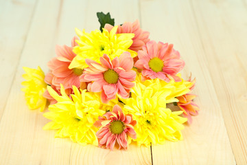 Chrysanthemum flowers on wooden table close-up
