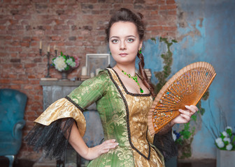 Beautiful woman in medieval dress with fan