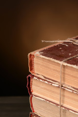 Old books on table on brown background