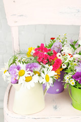 Bouquet of colorful flowers in decorative buckets,