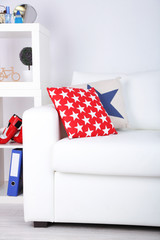 White couch with multicolor pillows and plaid in modern living