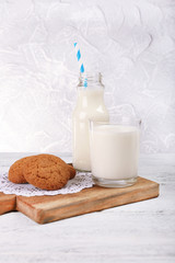 Milk and cookies on table on grey background