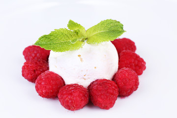 Creamy ice cream with raspberries and mint leaves isolated