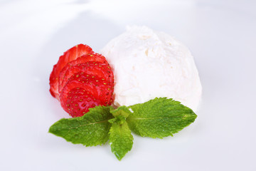 Creamy ice cream with strawberry and mint leaves isolated