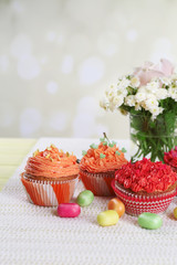 Fototapeta na wymiar Tasty cupcakes on table, on bright background