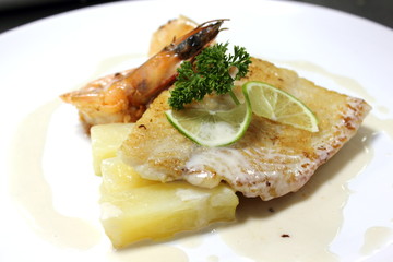Grilled shrimp and fish on the plate