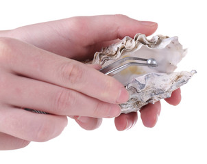Hand with tweezers holding pearl and oyster, isolated on white