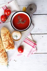Homemade tomato juice in color mug, bread sticks, spices and