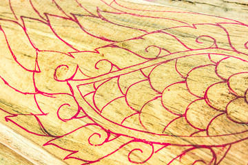 Painted on the wood before carving.