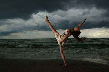 Young woman dancing on a beach