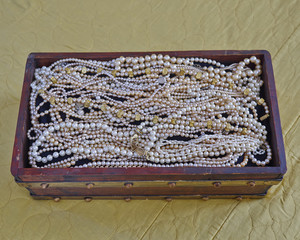 pearls in vintage wooden crib, precious background
