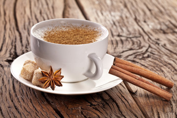 Cup of cappuccino decorated with spices.