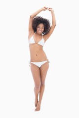 Fototapeta premium Athletic girl in white bikini smiling at camera