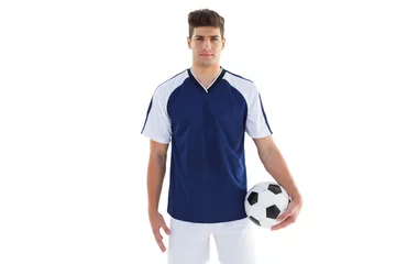 Gordijnen Football player in blue jersey holding ball © WavebreakMediaMicro