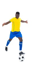 Fototapeta na wymiar Football player in yellow kicking ball