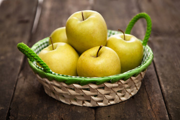 Fresh green apples and pears on a wooden table
