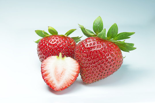 Isolated strawberries on white - Stock Image