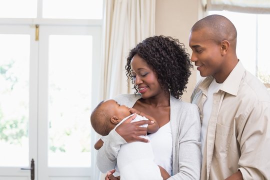 Happy young parents spending time with baby