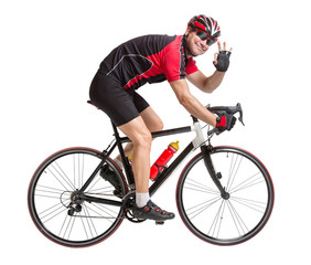 Fototapeta na wymiar cheerful cyclist with winning gesture riding a bike