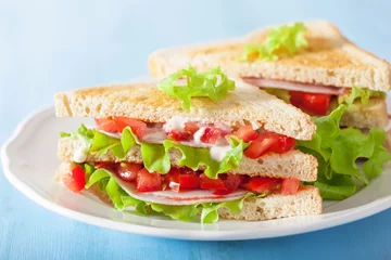 Fototapeten sandwich with ham tomato and lettuce © Olga Miltsova