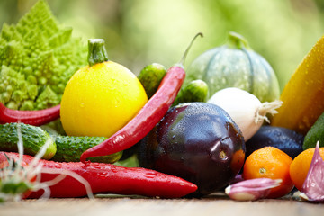 Fresh organic vegetables ane fruits on wood table  in the garden