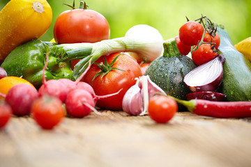 Fresh organic vegetables ane fruits on wood table  in the garden