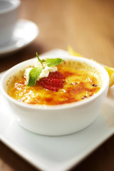 close up egg custard and strawberry in white dish