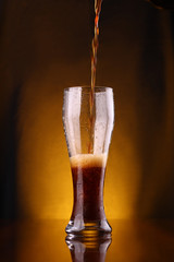 Dark beer pouring