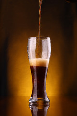 Dark beer pouring