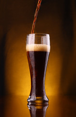 Dark beer pouring