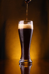 Dark beer pouring