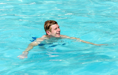 boy has fun swimming in the pool