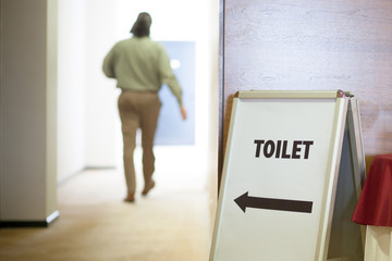 man going to toilet