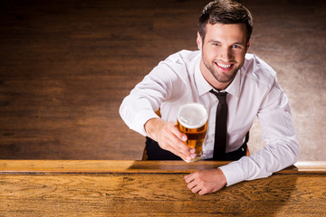 Relaxing with glass of fresh beer.