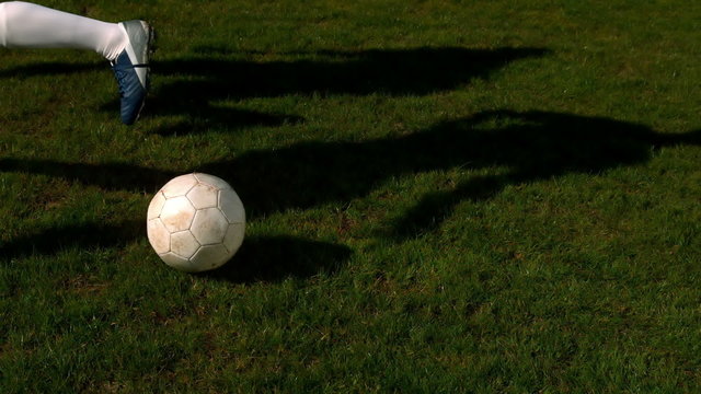 Football player controlling the ball on pitch