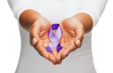 hands holding purple awareness ribbon