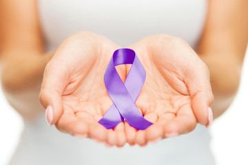 hands holding purple awareness ribbon