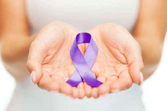 hands holding purple awareness ribbon