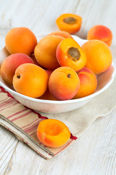 apricots in a bowl on wooden table