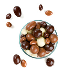 chocolate covered nuts and raisins isolated on white