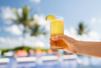 close-up of hand holding glass with cocktail