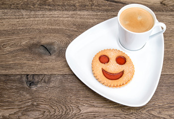 coffee with smiled cookie. funny breakfast