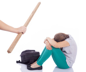 Male hand holding a wooden stick to beaten on a little girl, iso