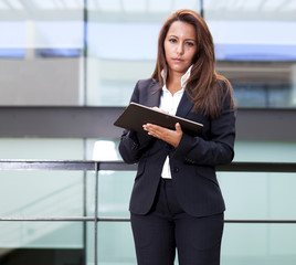 Fototapeta premium Young businesswoman using his digital tablet at the office
