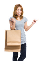 Woman with paper bag and finger point out