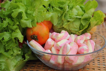 Vegetables salad, tomato and pink marshmallows.