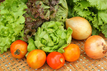 Obraz na płótnie Canvas Vegetables salad and tomato in the basket